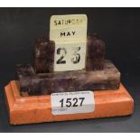 An Art Deco amethyst desk calendar, complete with rounded rectangular plastic inserts,