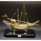 A cast silver and gold plated model boat