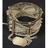 A silver identity bracelet;