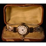 A George V lady's 9ct gold wristwatch, white enamel dial, Roman numerals,