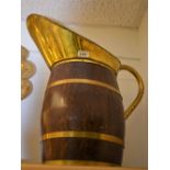 A substantial late 19th century brass bound oak jug, everted lip, loop handle, 50cm high, c.