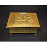 A late Victorian beaten brass box, hinged cover embossed with a three-masted ship,