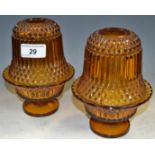 A pair of early 20th century amber glass night lights, moulded domes, 16.5cm high, c.