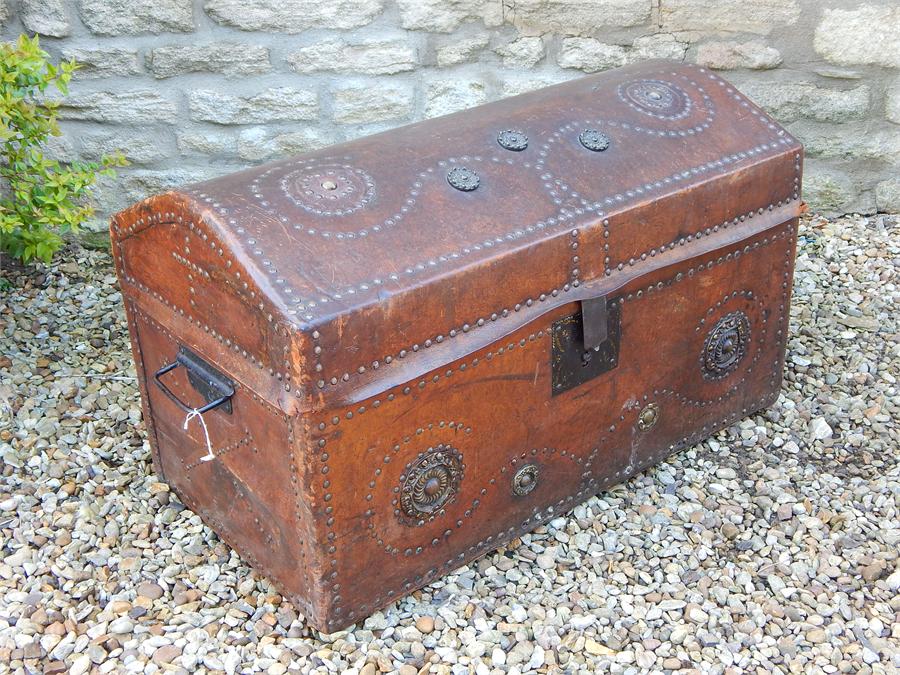 Leather clad brass studded dometop trunk.