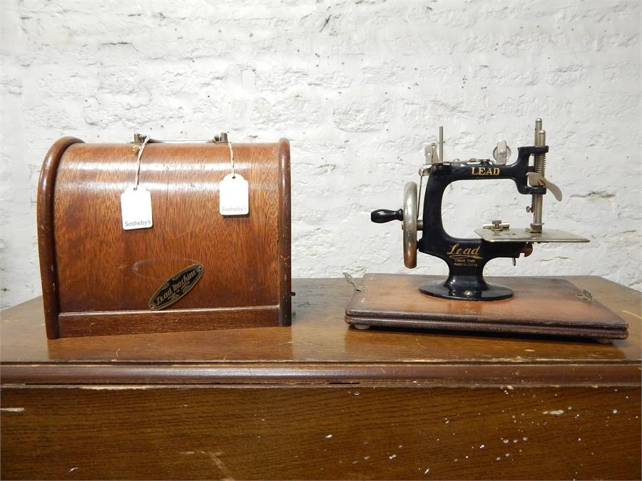 Small hand sewing machine, made by Lead in Japan. Dimensions are 6.5'', 9.5'' by 8.25'' with