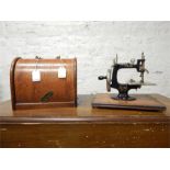 Small hand sewing machine, made by Lead in Japan. Dimensions are 6.5'', 9.5'' by 8.25'' with