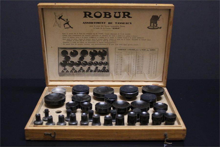 A Robur horologists watchmakers glass setting fitting tool set "Assortment de tasseaux" in wooden