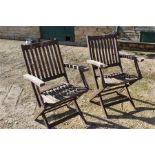 Two folding garden chairs.