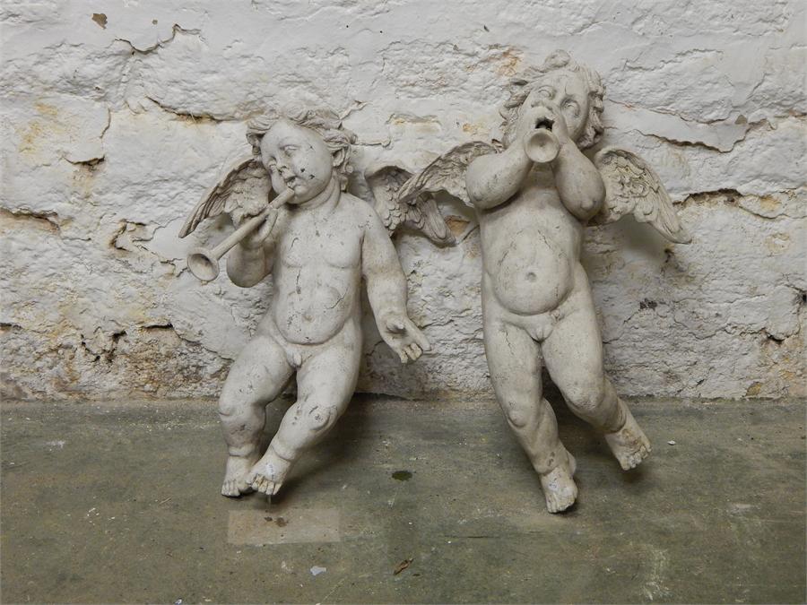 A pair of winged stone-effect resin flying cherubs / putti. Modern