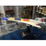 A vintage battery operated model toy of Concorde on stand