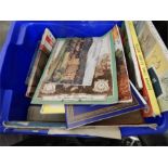 Books pamphlets. A blue plastic box of