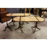 A Pair of Modern leather topped pedestal coffee tables, with brass paw castors and a small