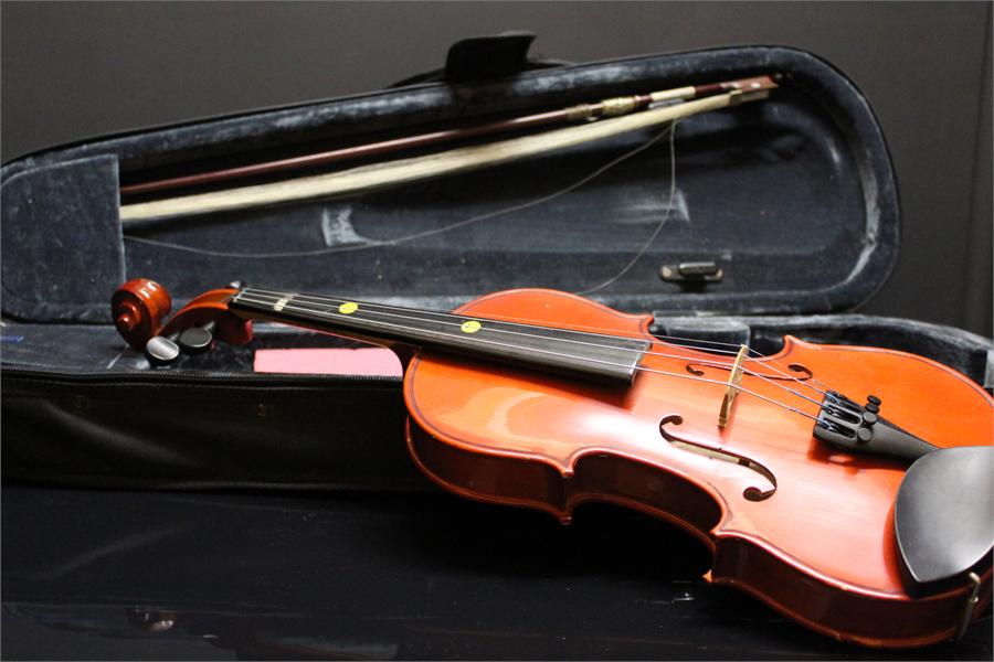 Quarter Violin in case with bow.