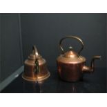 A 19th century copper kettle and a copper and brass bell shaped kettle.