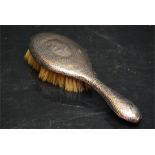 a silver backed natural bristle ladies hair brush with wear to the bristle