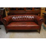 19th century leather chesterfield settee / sofa with turned supports and brass castors