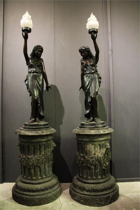 A pair of 19th / 20th century bronze circular column plinths with lion and floral swag decoration,