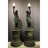 A pair of 19th / 20th century bronze circular column plinths with lion and floral swag decoration,