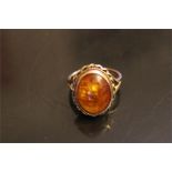 oval amber set in 9ct gold dress ring - Birmingham mount - Maker P&G