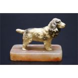 A cold painted metal spaniel dog on marble mount.