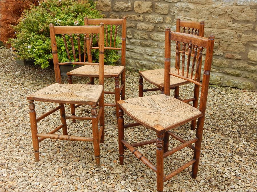 A Set of Four Matching Elm Country Kitchen Rush Seated Side Chairs, turned spindle Backs in a fan