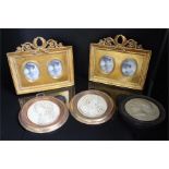 pair of modern freestanding picture frames and three plaster portraits in gold colour frames