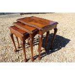 Nest of three 20th century walnut tables