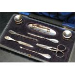 an early Victorian travelling manicure set in a sloped calf leather embossed box. silver plated