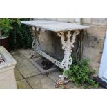 A painted cast iron / metal garden table with weathered top, appears to be marble. The dimensions