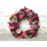 Large wreath with faux roses and apples.