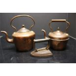 two copper kettles and a cast iron