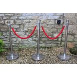 three Chrome barrier stands and two ropes