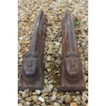 Pair of cast iron andirons with faces