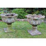 Pair of shaped garden urns. 49cm high 49cm wide.