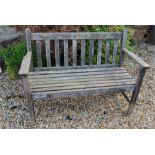 Weathered garden bench - appears to be oak.