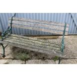 Weathered garden bench with cast metal ends.