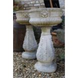 Pair of concrete garden urns in two parts with rosette decoration.