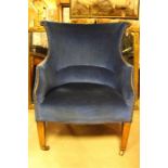 A pleasing 19th century wing / barrel back armchair. The chair supported upon patinated mahogany