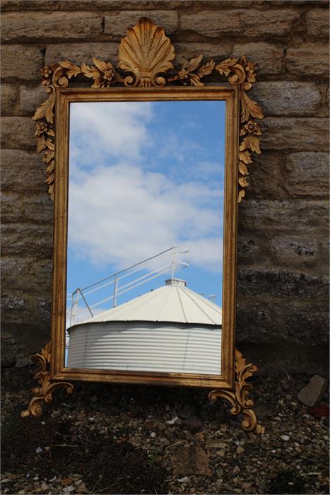 Carved giltwood mirror of George III style with shell surmount