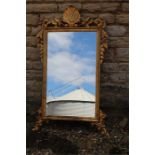 Carved giltwood mirror of George III style with shell surmount