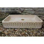 A lunette carved stone sink.