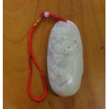 Chinese jade pendant decorated with a carved dragon fighting a tiger, 7.5cm long