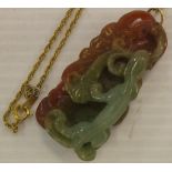 Finely carved Chinese stone pendant depicting a lizard on foliage, 5.5cm long approx.