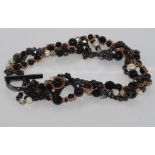 Mimco statement necklace of woven black and rose gold chains with glass ivory pearls and glass