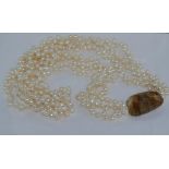 Three strand baroque pearl necklace with feature stone