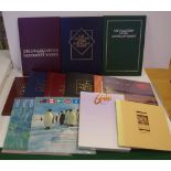 Seven Australian stamp year books together with 5 commemorative stamp packs, each containing