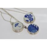 Three silver & ceramic lockets on silver chains