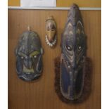 Three vintage PNG carved timber tribal masks 27cm, 42cm and 83cm high approx