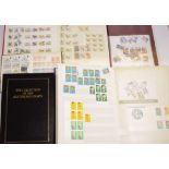 Four albums of Australian stamps containing many unused, together with 1 album of world stamps