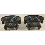 Two early large Chinese cloisonne bowls with bird and floral decoration, on three figural feet,